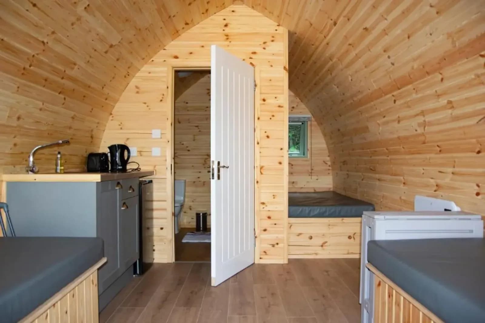 Inside a cabin: kitchenette, beds and shower room