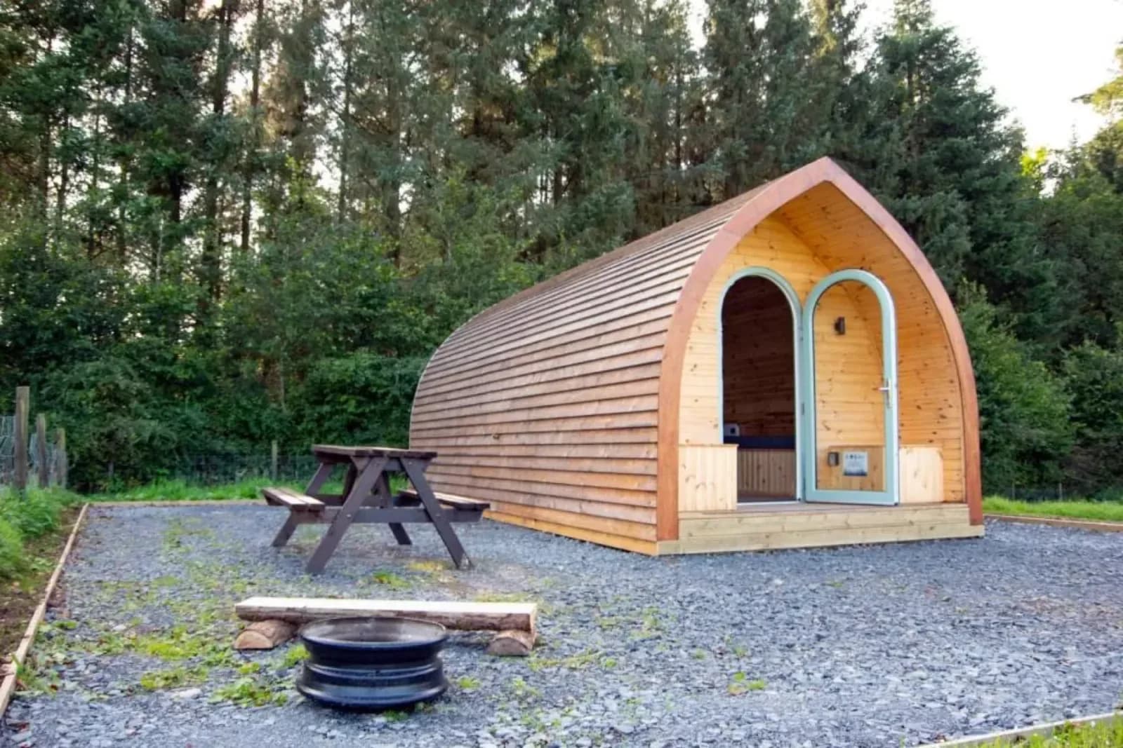 A timber cabin at the edge of the trees